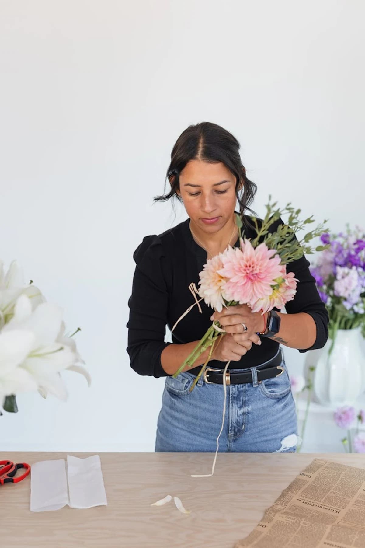 Celenia arranging flowers at her studio in Bristow, Virginia