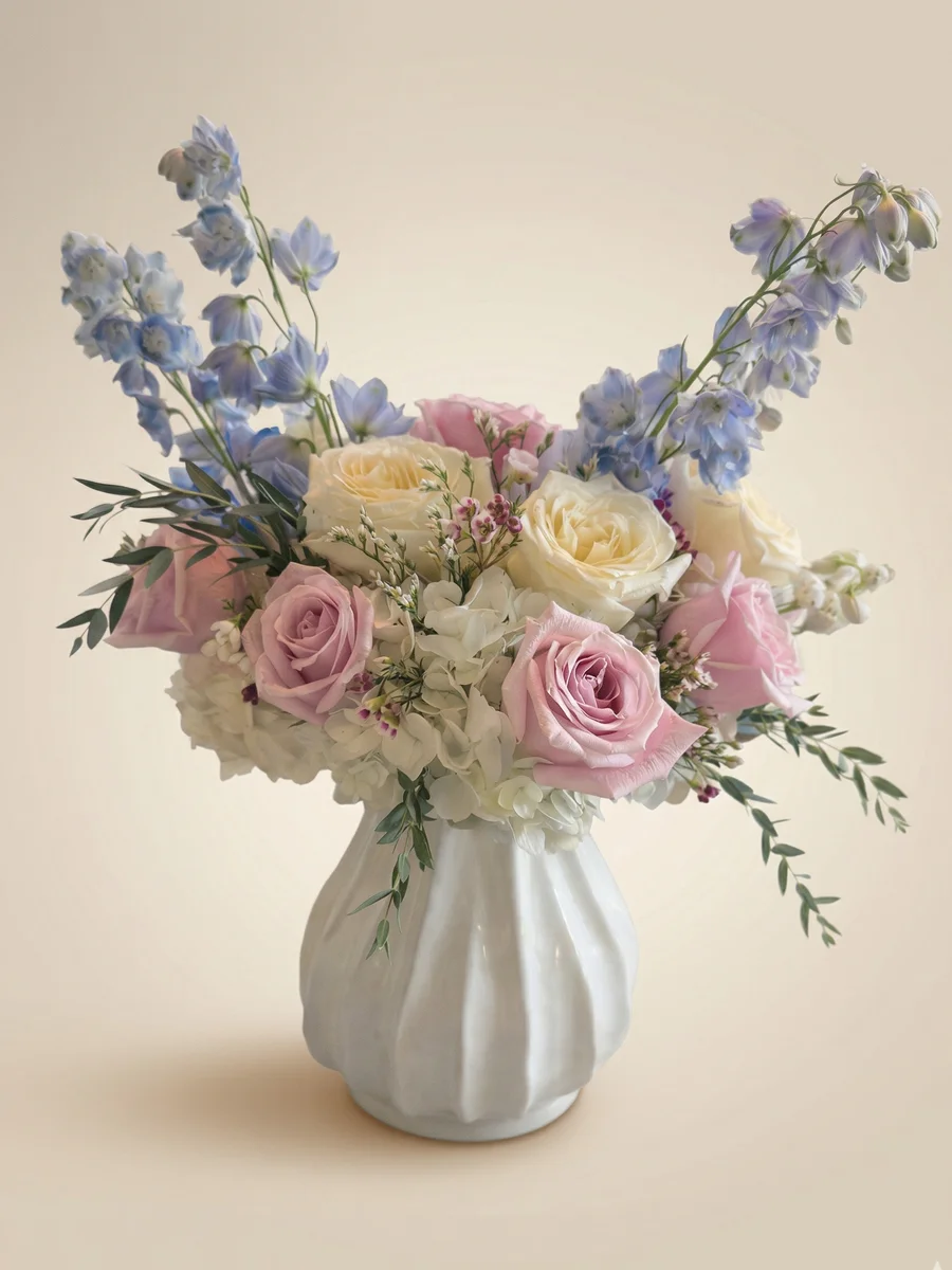 The Bloom - new baby flower arrangement with pink and yellow roses, white hydrangeas, and lisianthus