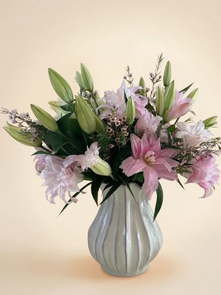 The Camille - soft pink double lily arrangement with wax flowers and wispy greenery